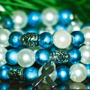 Blue and white beads with silver accent beads and a awareness ribbon charm bracelet