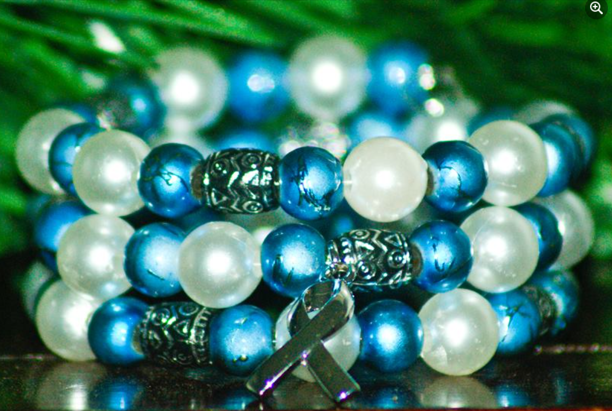 Blue and white beads with silver accent beads and a awareness ribbon charm bracelet