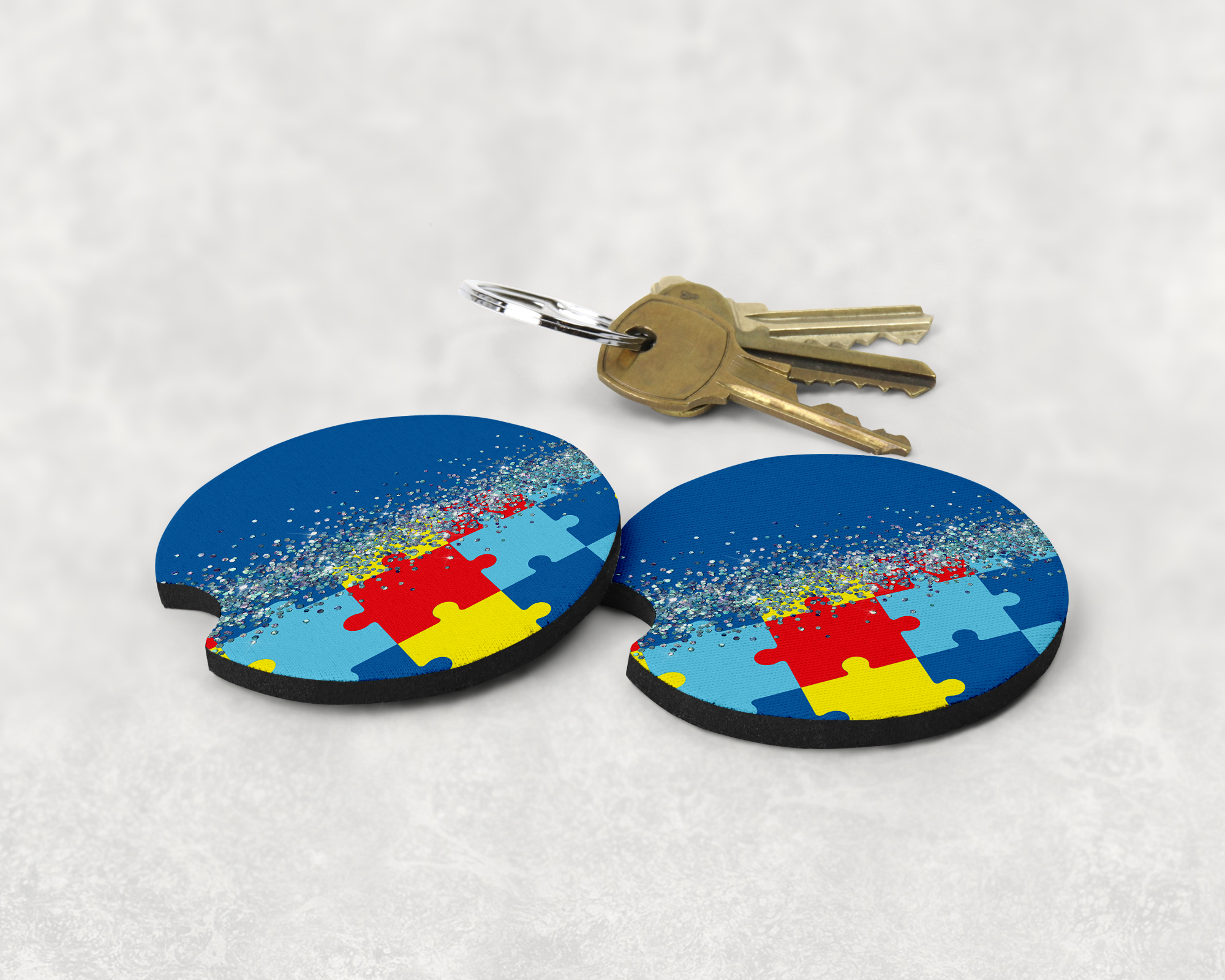 2 autism glitter car coasters with a set of keys mockup